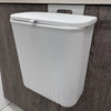 Space-saving cabinet-door trash can with sliding cover