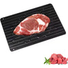 Aluminum defrost tray thawing a raw steak