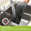 Defrost tray being rinsed clean under running water