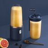 Portable blender bottle size reference next to a hand